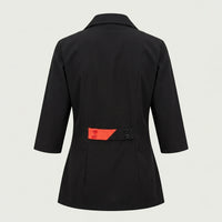 Back view of custom black salon tunic with coral back-belt detail by ausman