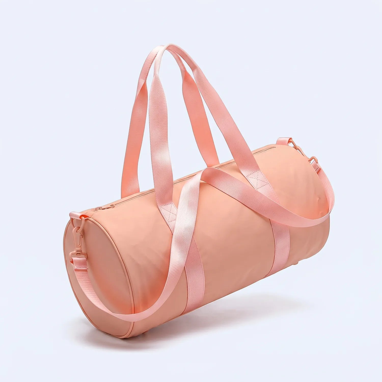 Pink duffel bag with ribbons on a light gray background