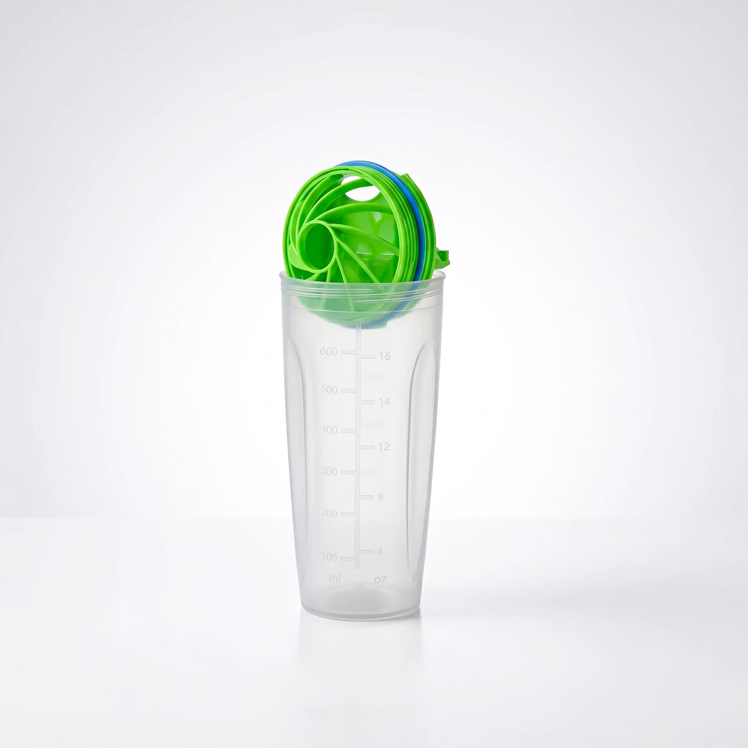 Clear tumbler with green and blue lid on a white background