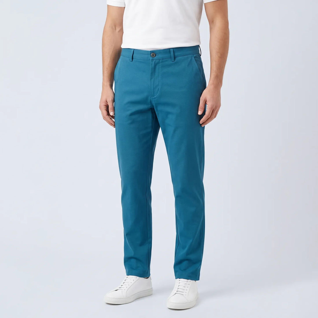Parline Golf Pant in teal, front view showing the belt-loop waistband, button-and-fly closure, and slant pockets.