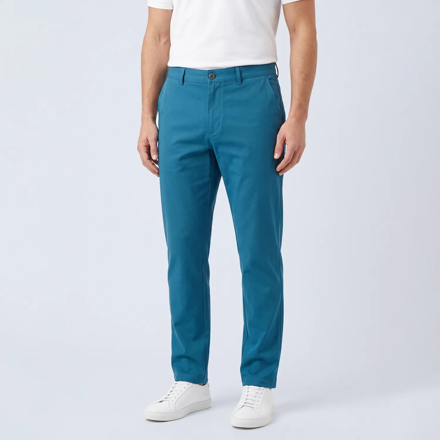 Parline Golf Pant in teal, front view showing the belt-loop waistband, button-and-fly closure, and slant pockets.