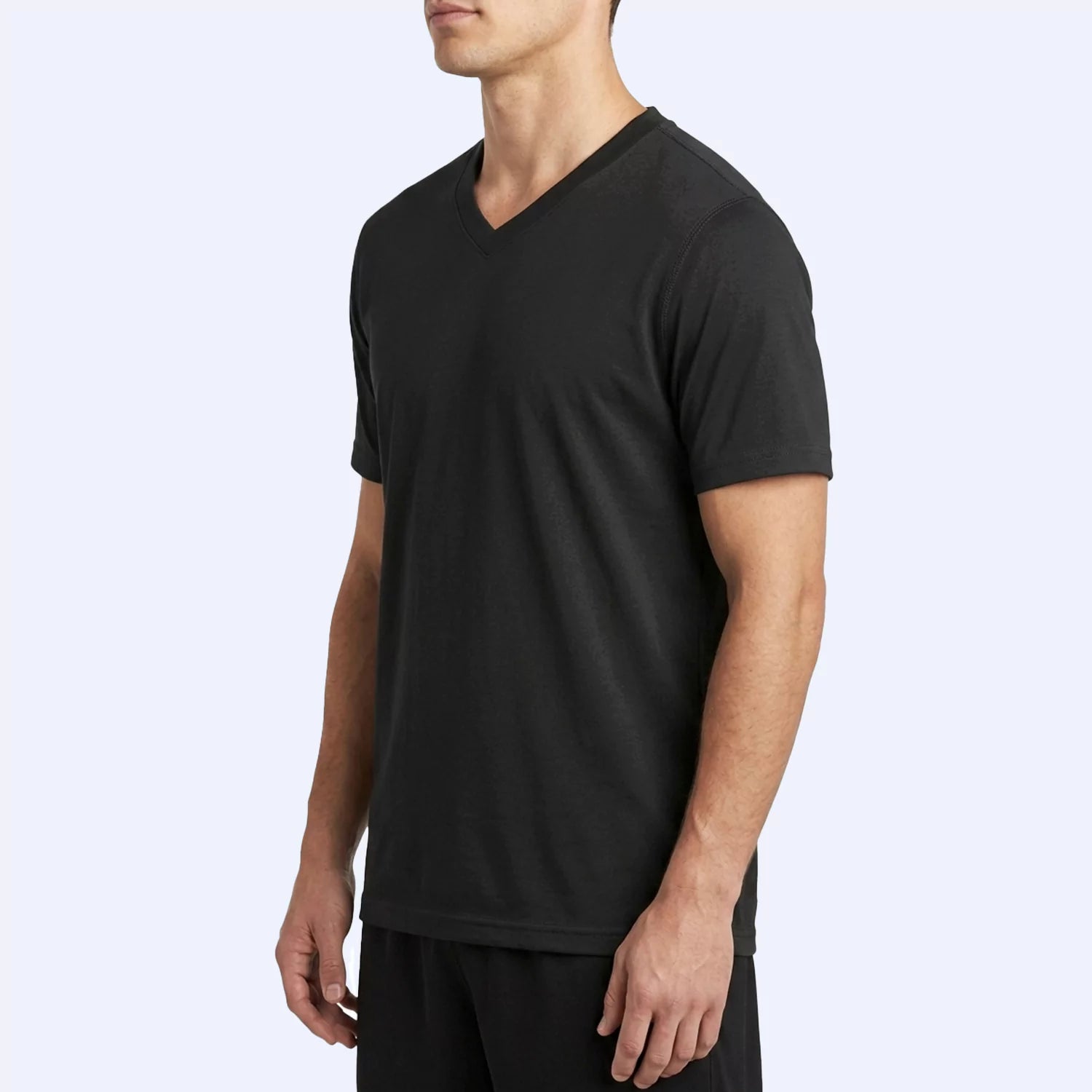 Side angle of the black Vortex V-neck tee showing slim fit through the torso